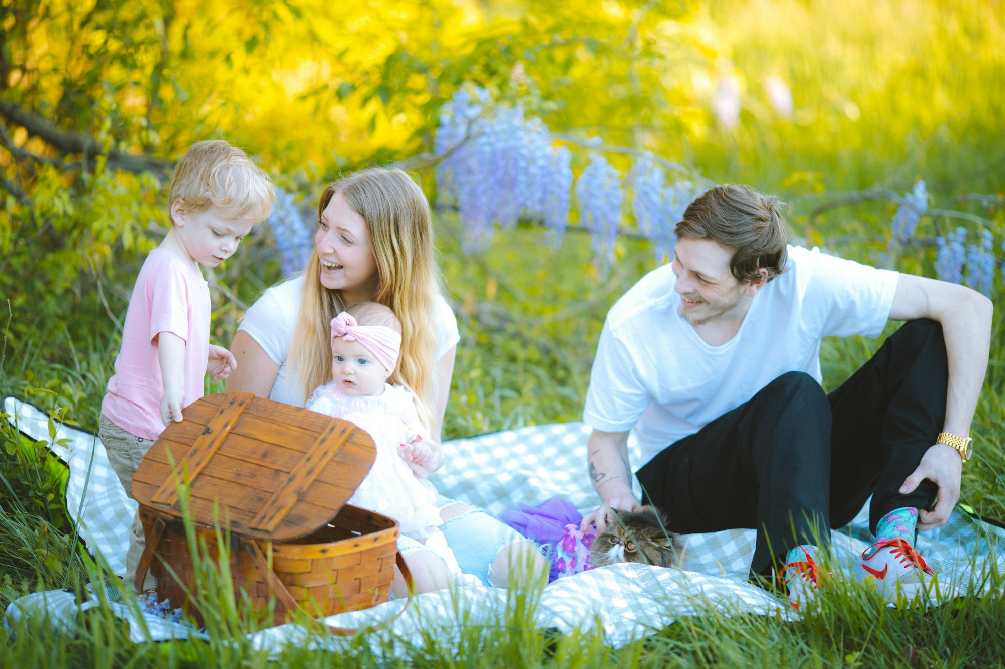 Parents and a child relaxing on a picnic blanket